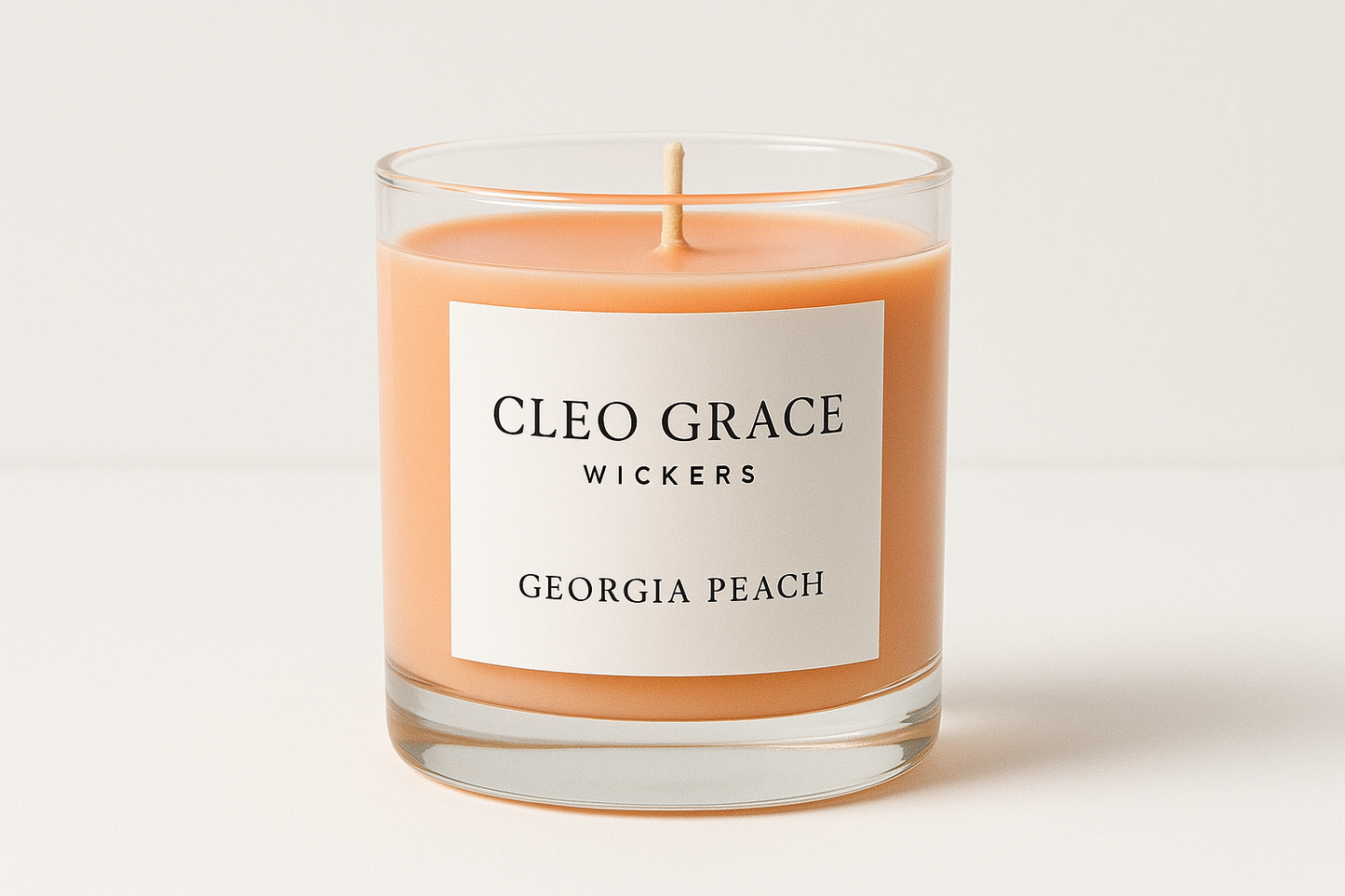 Georgia peach candle with Cleo Grace Wickers on white lable